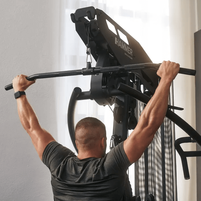 Hammer Lat Bar Black Showcasing Someone Holding It On The Ends Of The Knurled Grip Hammer Lat Bar Black Showcasing Someone Holding It On The Ends Of The Knurled Grip